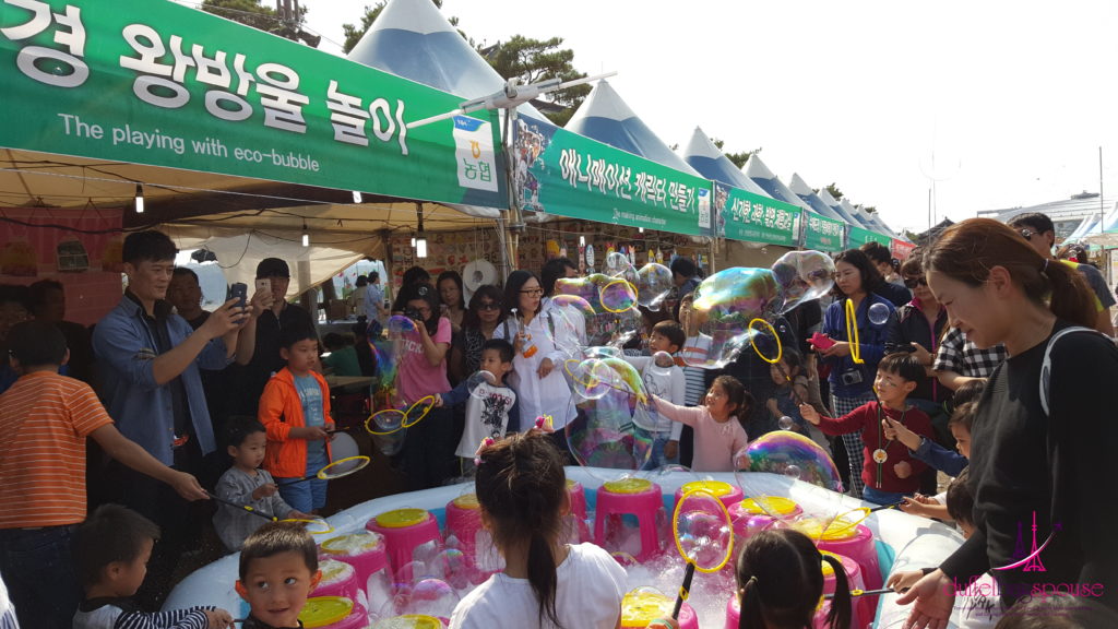 Little kids enjoying the Andong Mask Dance Festival in South Korea