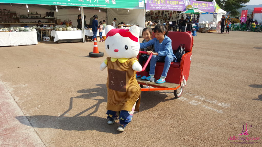 Two kids enjoying animatronics at the Andong Mask Dance Festival in South Korea