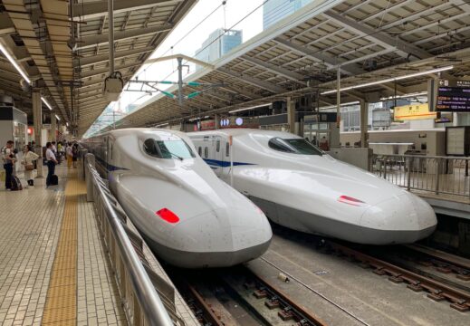 white bullet trains in train station