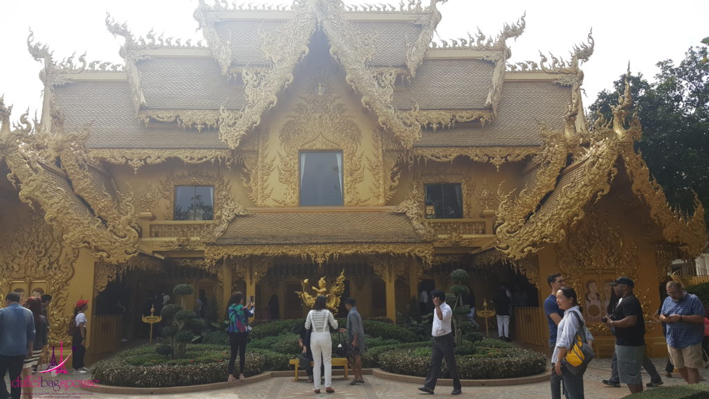 golden toilets The pretty pond and bridge behind the monastery at Chang Rai's Wat Rung Khun.