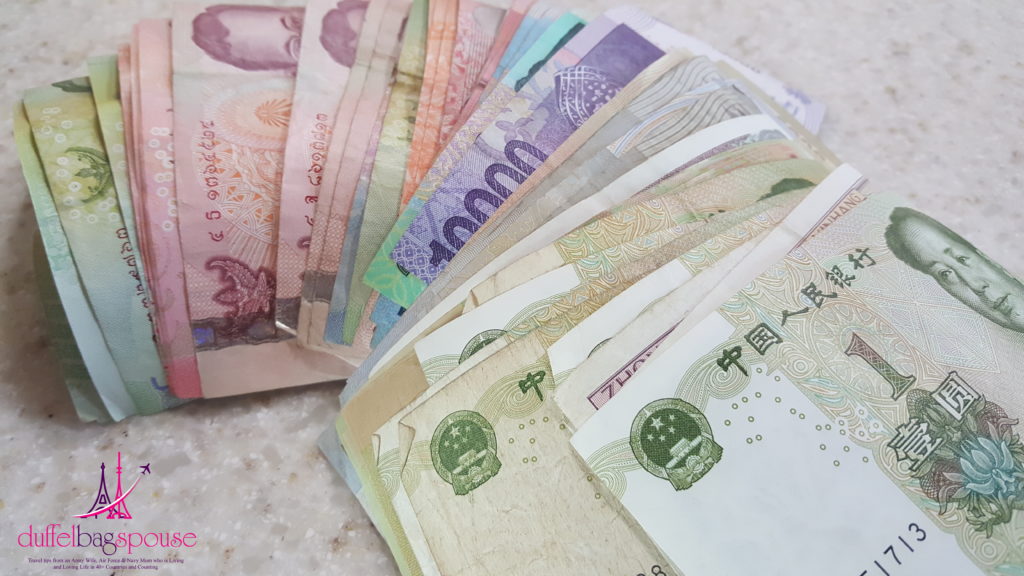 26 Signs You are Addicted to Travel- stack of foreign currency