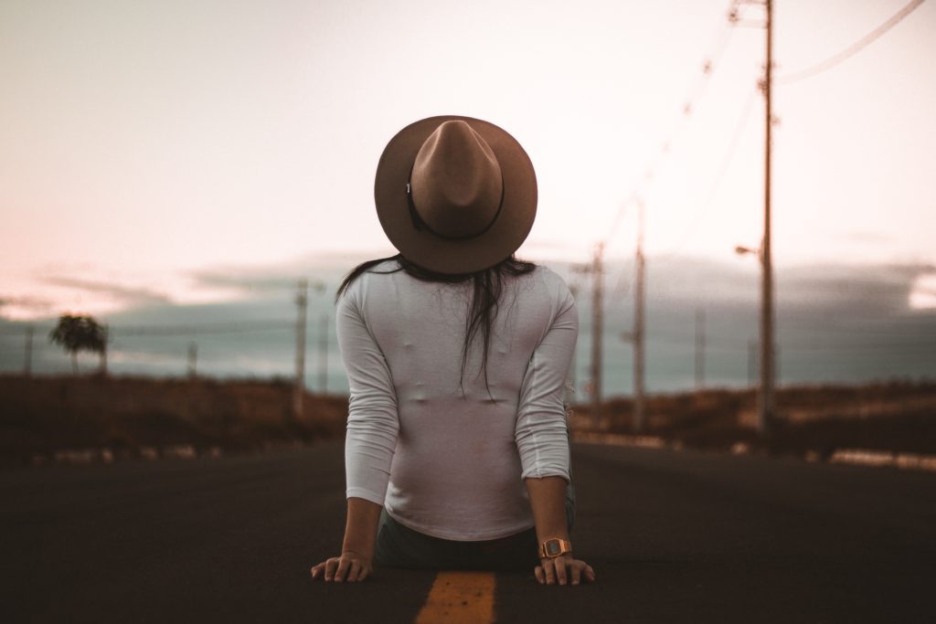 26 Signs You are Addicted to Travel- girl in the middle of the road
