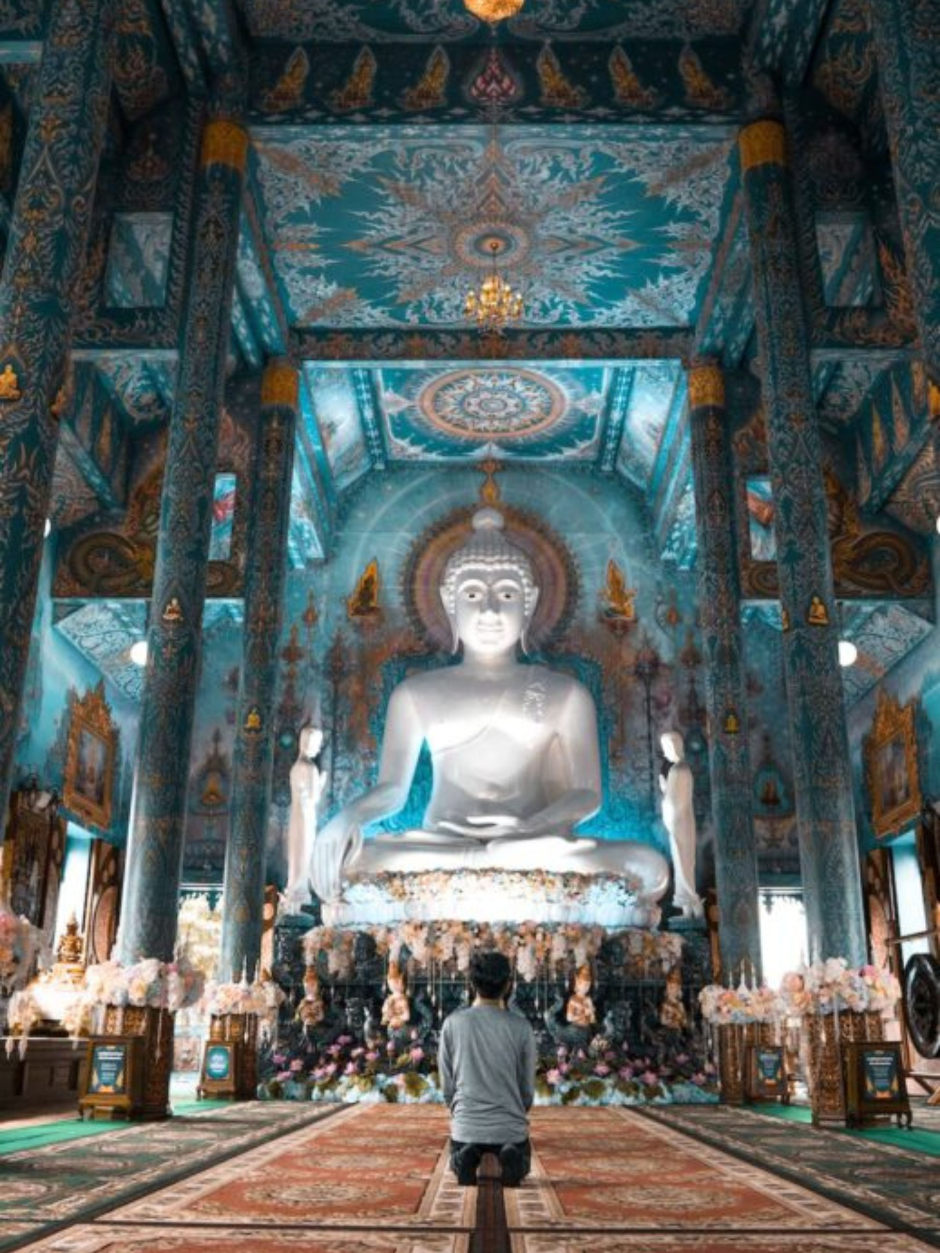 a person praying at Buddha for good luck
