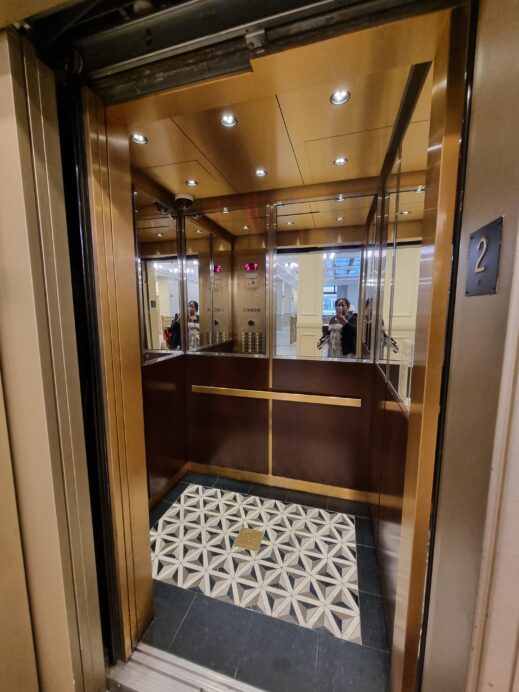 inside bronze art deco elevator view Hotel Saint Louis