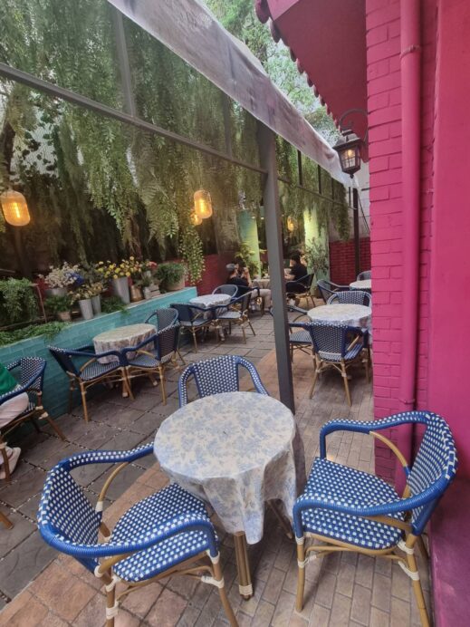 Blue patio chairs pink wall