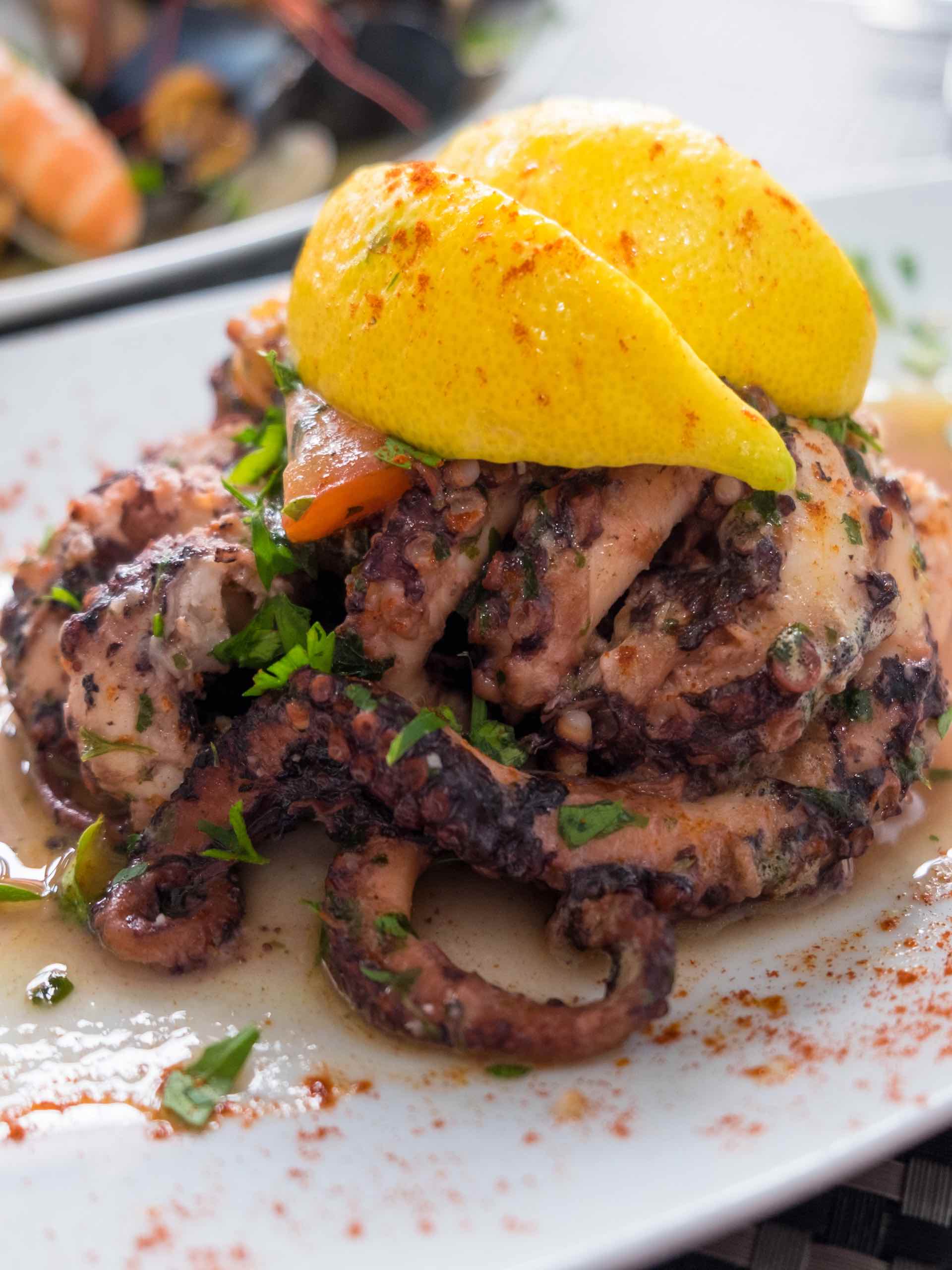 Freshly caught octopus grilled with garlic and olive oil and served with wine sauce-featured image
