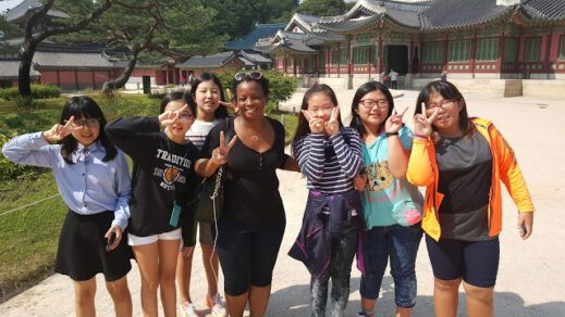 Stacey-with-Korean-school-girls-519x292 What's UP with the Peace Sign in South Korea