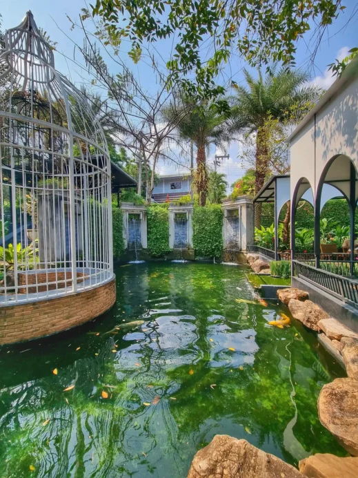 2 story birdcage koi pond outside at Fleur Cafe & Eatery