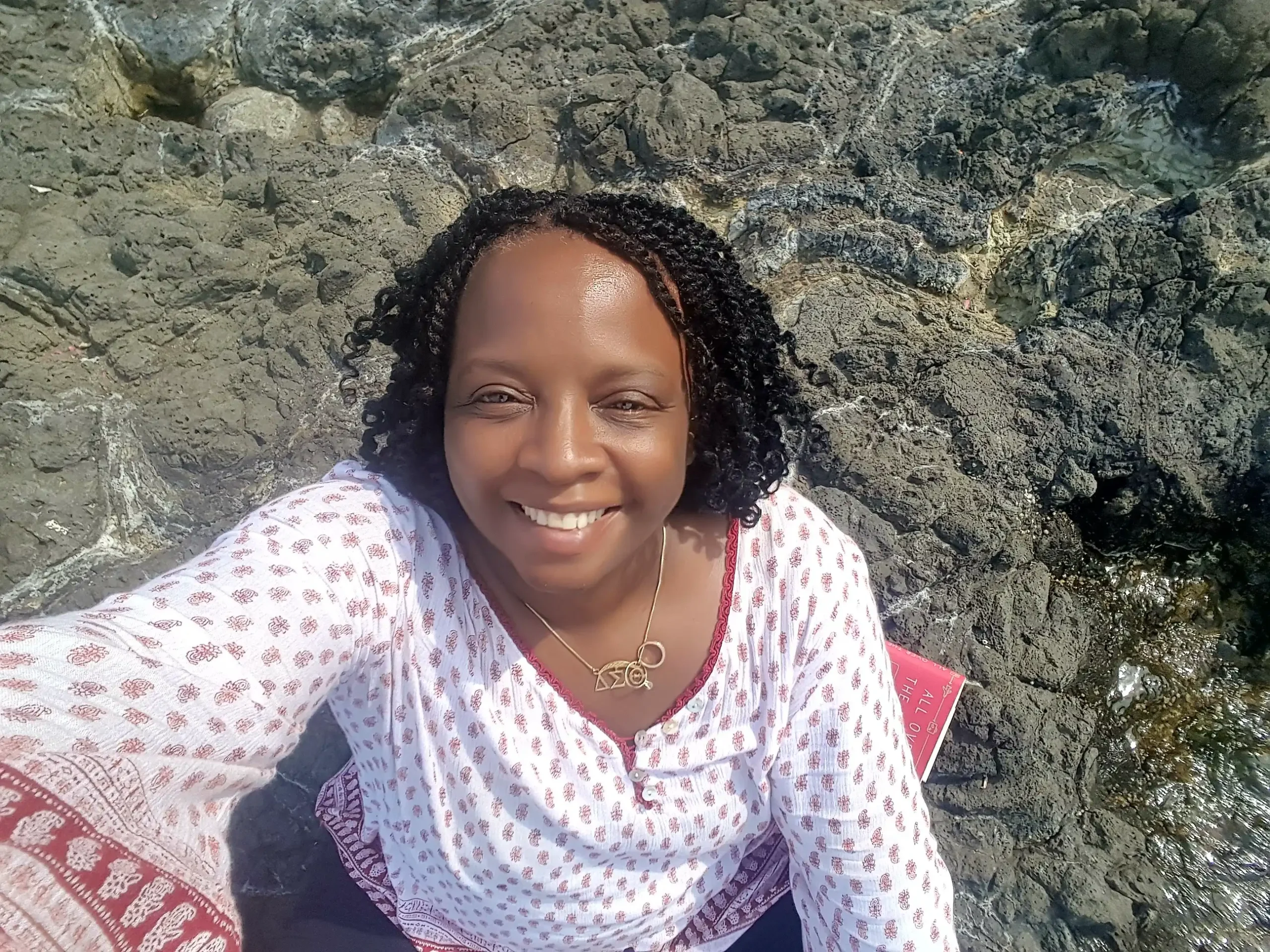 Stacey, at beach, Sicily, rocky beach