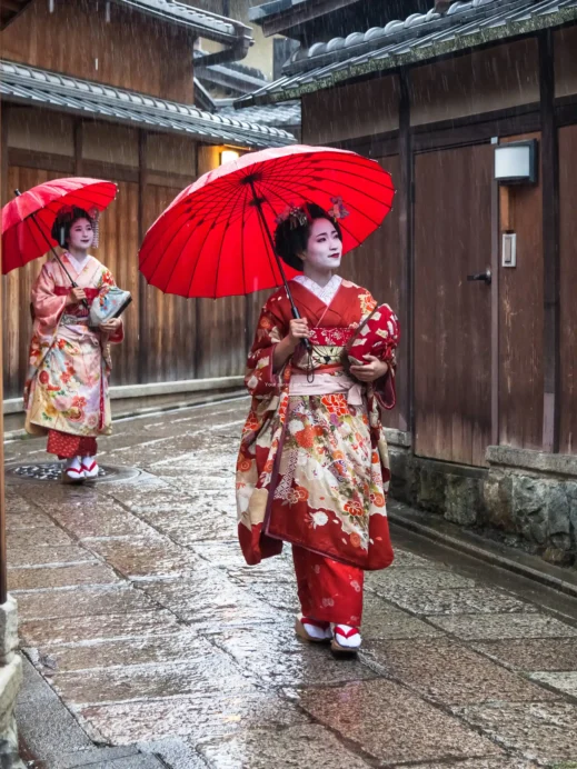 female Geishas on the rainy streets