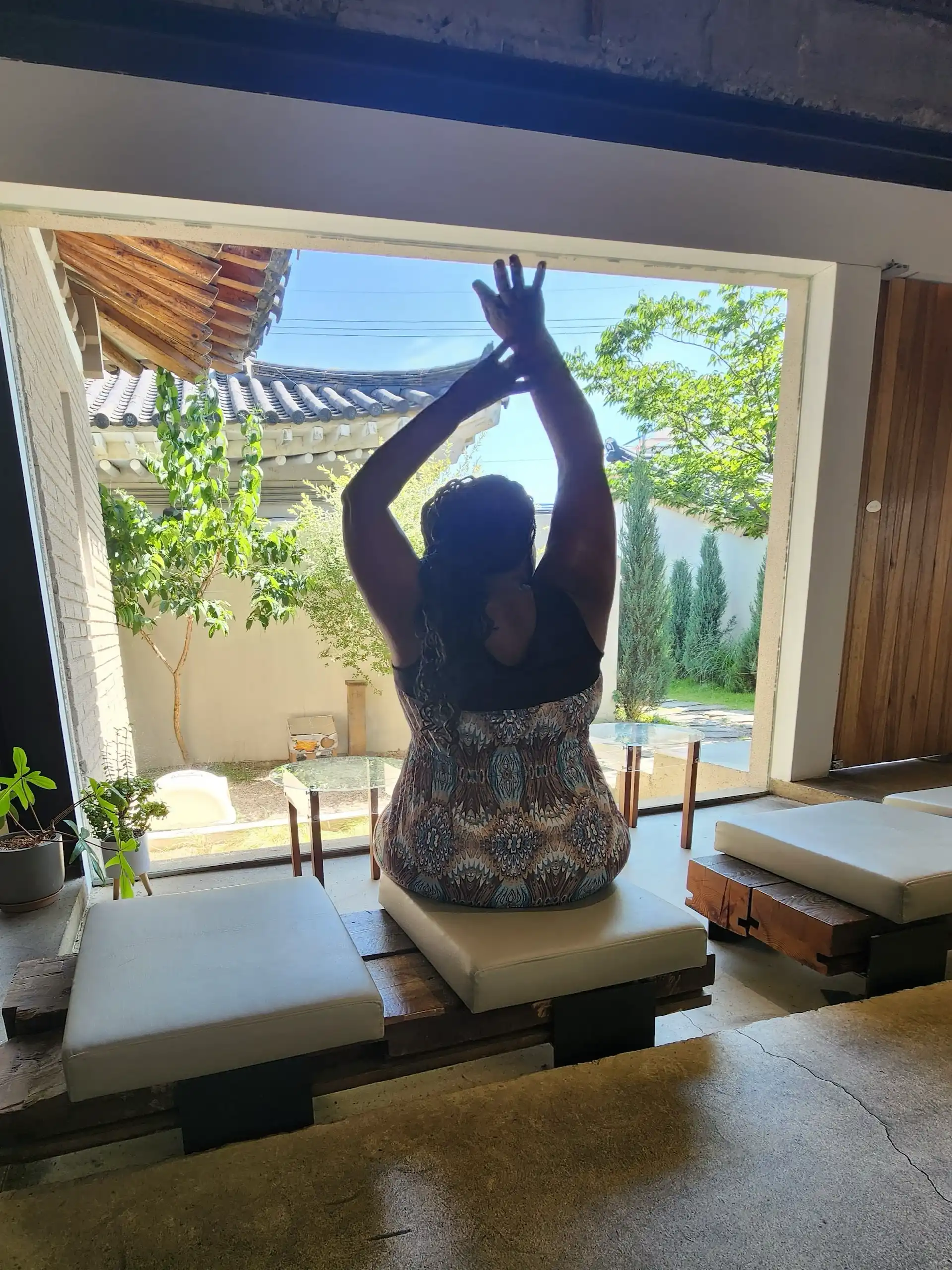 Stacey yoga stretch in Gyeongju cafe