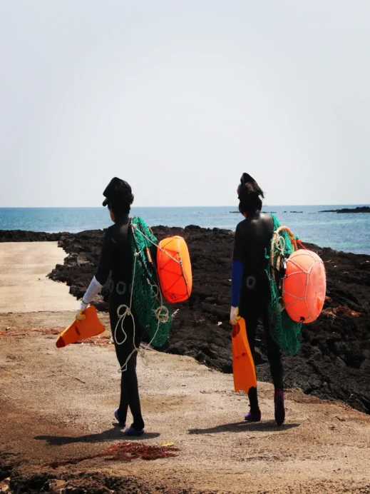 Jeju Photo Haenyo women walking red floaties