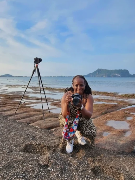Jeju Photo Stacey kneeling camera tripod Sunrise Peak