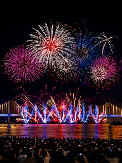 Multicolored Fireworks Over the Illuminated Busan Bridge